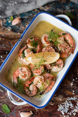Lemon garlic butter shrimp on wooden background