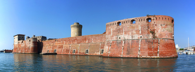 Moated Fortezza Vecchia Castle with its thick waterfront walls in Livorno, Italy