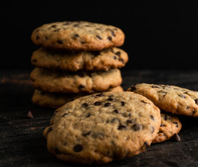 Chocolate chip cookies close up, over a black background