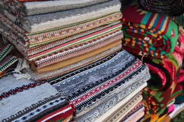 Uktainian traditional fabric carpets for sale on Sorochyntsi fair outroors. Local traditions of Ukraine, Europe