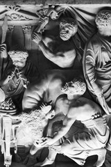 Black and white photo of  old carved sculptures on marble showing animal sacrifice scene in an ancient roman party