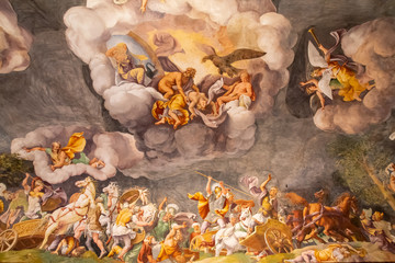 Old medieval italian fresco showing battle in heavens and on earth
