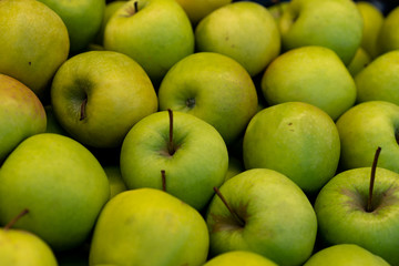.Green apples on a storefront for sale