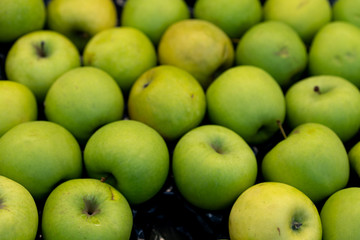 Green apples on a storefront for sale