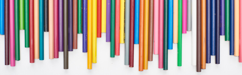 Panoramic shot of bright color pencils isolated on white