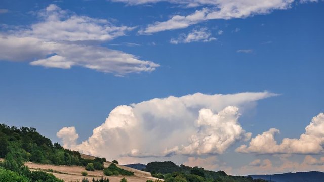 Timelapse - Massive clouds in the distance rising high into the sky