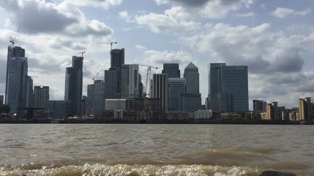 canary wharf economy  financial and business, across river thames London UK - stock video footage real time