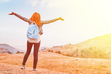 Beauty woman outdoors enjoying nature. Women enjoying nature in meadow. Outstretched arms fresh morning air summer Field at sunrise.