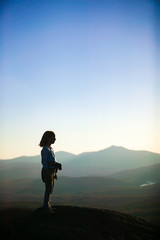 Young girl looking out from on top of a mountain, Stowe, Vermont, USA