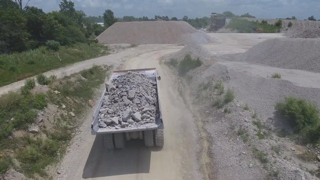 Aerial view of a big dump truck on a granite quarry