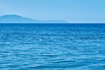                                Blue sea water texture with foggy sea coast on a horizon. Copy space.