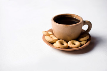 Rosquillas on a traditional Nicaraguan coffee cup made of clay. White background without people. Nicaraguan breakfast.