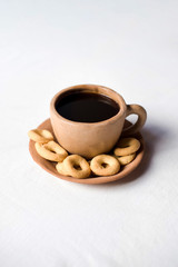 Rosquillas on a traditional Nicaraguan coffee cup made of clay. White background without people. Nicaraguan breakfast.
