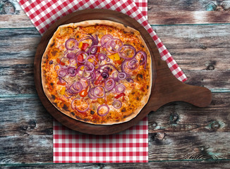 Original Italian pizza Peperoni and Onions on the wooden plate. Set for menu or banner.  Concept Pizza delivery service to home