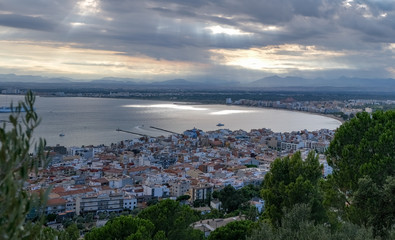 View on the wonderful resort town. A cloudy overcast day with rays of sunlight. Amazing resort destination. Mediterranean resort in a wonderful bay on a cloudy sunset.