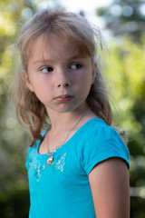 Little girl looking camera right in blue dress