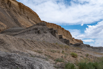 Stark landscape of grey and yellow rock formations or hills near Hanksville, Utah
