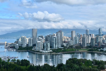 Fototapeta na wymiar Vancouver skyline on a summer day. False Creek, Vanier Park, Burrard Bridge, Yaletown, West End and Seawall from above. Vancouver Downtown, British Columbia. Canada.
