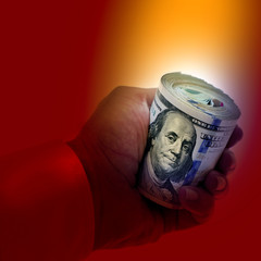 close up businessman hand holding rolled up American hundred dollars pile over white background