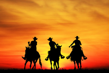 silhouette Cowboy riding a horse on sunrise