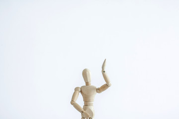 wooden figure of man with hands up