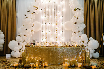 Table setting for wedding. Decorated arch for wedding ceremony. White balloons, candles, autumn...