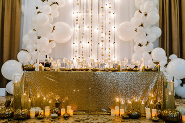 Table setting for wedding. Decorated arch for wedding ceremony. White balloons, candles, autumn...