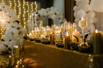Decorated table for wedding. White balloons, candles, autumn leaves and small pumpkins. Autumn...