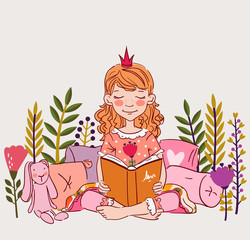 Cute little girl with crown reading a book in the garden