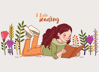 Cute little girl reading a book in the garden