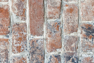 Background of vintage blue painted brick wall with old graffiti. Vertical brick wall texture.