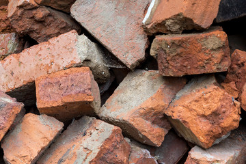 A pile of old broken red bricks