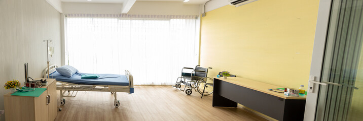 Background of the patient room with a wheelchair, bed and the light from the window. Panorama...