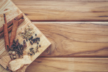 Many Chinese medicines that are put together on a light brown wood floor.