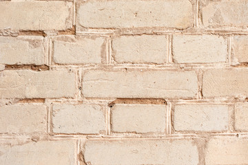 Fototapeta premium Texture of a brick wall with cracks and scratches which can be used as a background