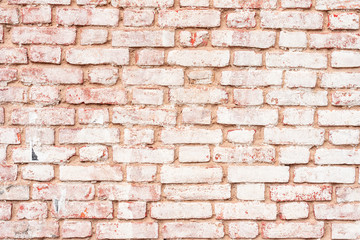Fototapeta premium Texture of a brick wall with cracks and scratches which can be used as a background