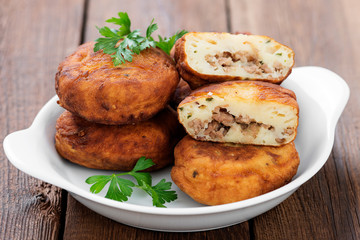 Potato patties (zrazy) Stuffed with minced meat, served with sour cream and tomato sauce.