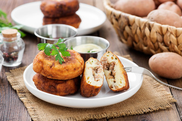 Potato patties (zrazy) Stuffed with minced meat, served with sour cream and tomato sauce.