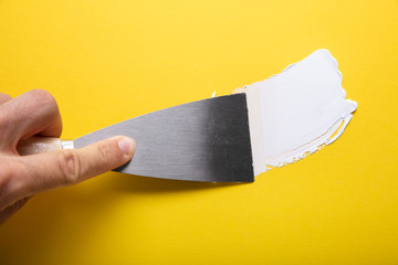 Painter Puttied Yellow Wall With Paint Trowel