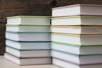 stacks of books on a wooden background