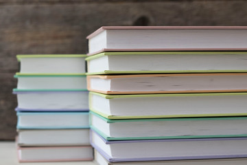stacks of books on a wooden background