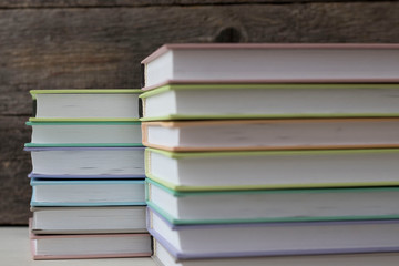 stacks of books on a wooden background