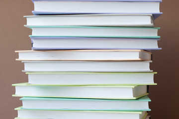 Stack of colorful books on brown background . Education background. Back to school.