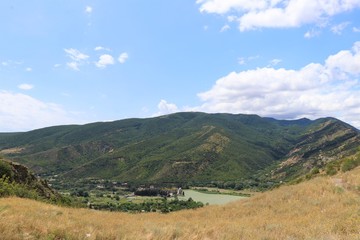 Aerial panoramic view of Mtskheta village, near Tbilisi, where the Aragvi river flows into the Kura river. View from the Jvary monastery hill. The Mtskheta village is part of the UNESCO heritage site.