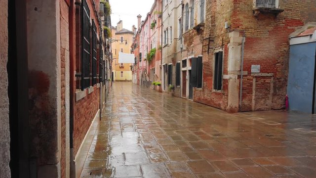 VENICE, Italy - May 2019: traditional street in Italy. Wet asphalt after rain. Slow motion.