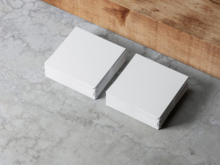 Stacks of white square paper sheets mockup on concrete floor