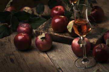 French apple strong alcoholic drink, still life in rustic style, vintage wooden background,...