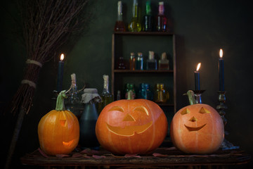 Halloween decoration with pumpkins and magic potions indoor