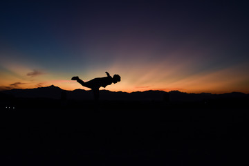 Silhouette of man doing at sunset, Concept lifestyle freedom vacation travel.