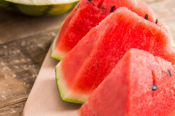 Slices of watermelon on wooden table, Closeup